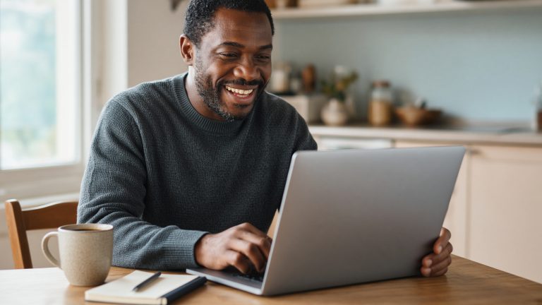 A welcome email with account details open beside a laptop